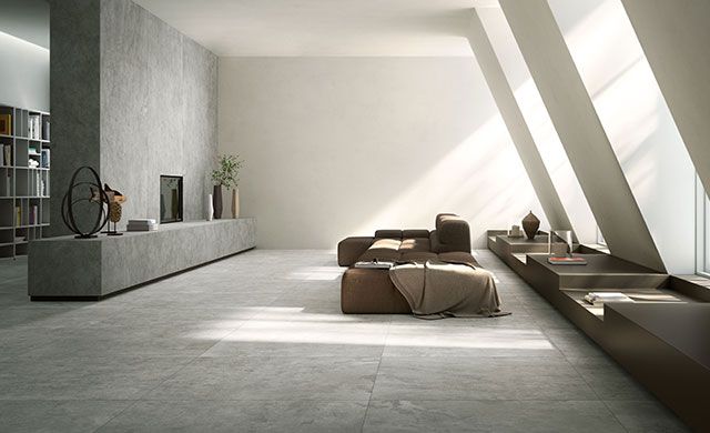 Foto: Fiandre | Fliesenserie: Quietstones Maximum Modernes Wohnzimmer mit großen Fliesen in Steinoptik der Serie Quietstones Maximum von Fiandre